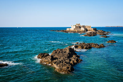 Fort national and rocks during high tide a sunny day of summer in saint malo. brittany, france