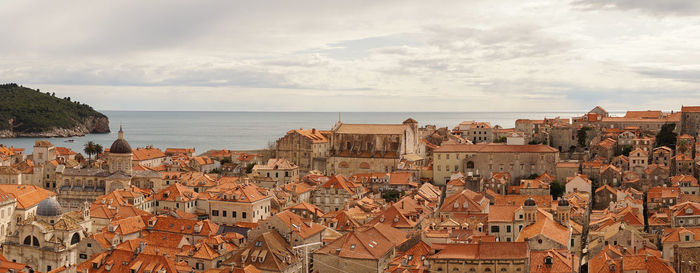 Aerial view of townscape by sea