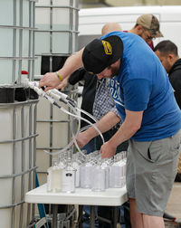 Side view of people working in factory