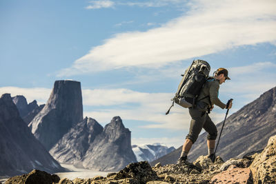 Backpacker on the move on rugged mountain ridge.