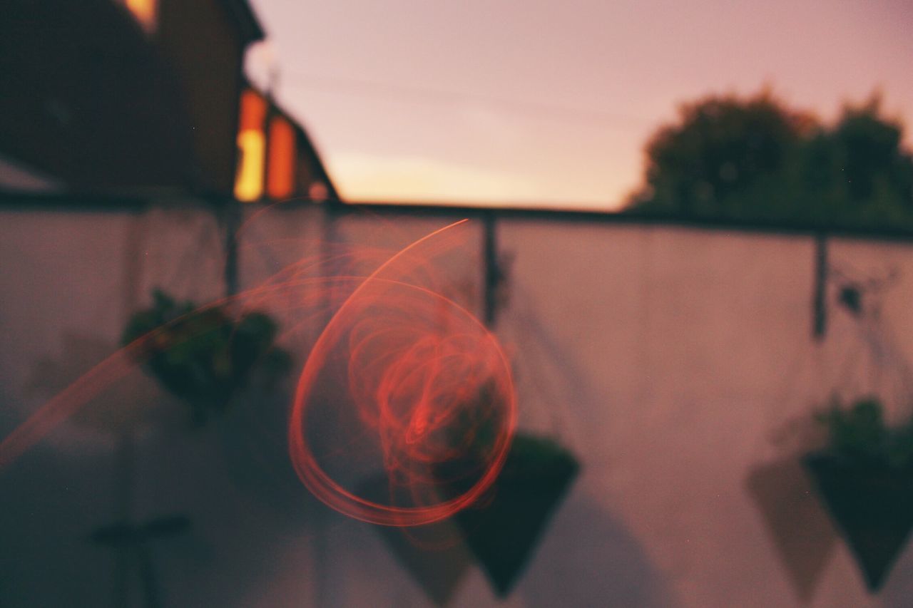 sunset, focus on foreground, selective focus, close-up, silhouette, orange color, sunlight, no people, sky, lens flare, illuminated, outdoors, dusk, table, tree, nature, red, glass - material, shadow