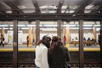 People waiting at railroad station platform