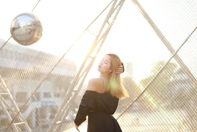 Full length of young woman playing soccer