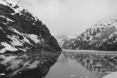 Reflection of snowcapped mountains in lake against sky