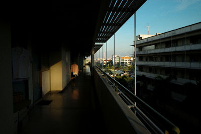 Bridge amidst buildings in city against sky