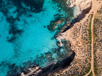 High angle view of rock formations in sea