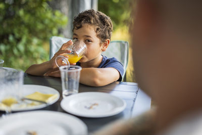 Boy drinking juice at table