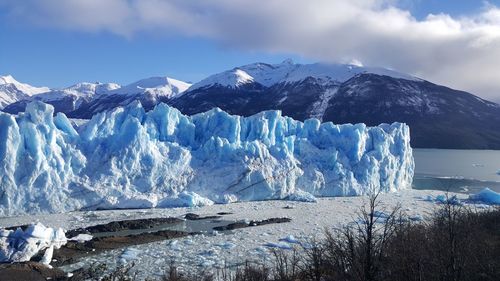 Panoramic view of frozen sea against mountain