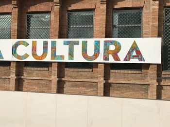 Close-up of text on brick wall