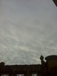 Low angle view of building against cloudy sky