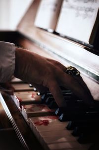 Close-up of man playing piano