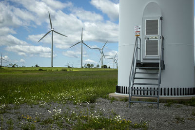 Traditional windmill on field against sky