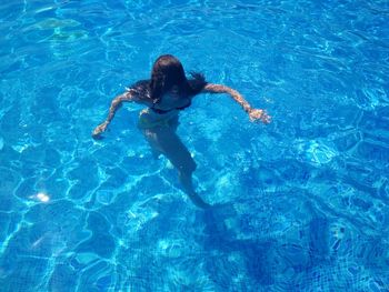 High angle view of woman swimming in pool