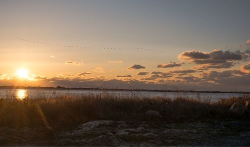 Scenic view of lake against sky during sunset