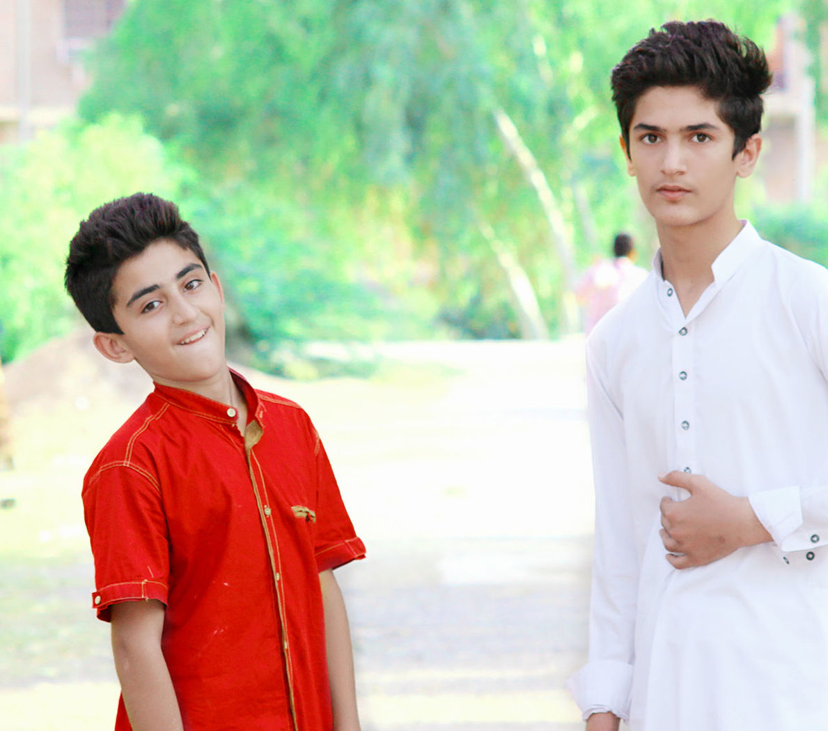 looking at camera, young men, young adult, portrait, standing, real people, focus on foreground, two people, front view, clothing, people, red, handsome, togetherness, three quarter length, day, men, beautiful people, couple - relationship