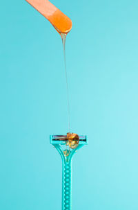 Close-up of umbrella against blue background