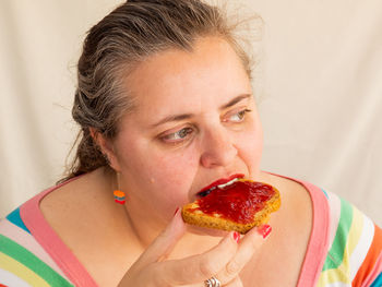 Close-up portrait of woman eating food