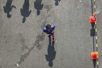 High angle view of people standing on road