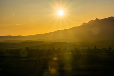 Scenic view of silhouette mountains against sky during sunset