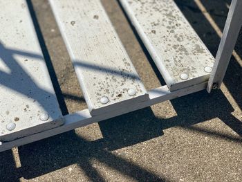 High angle view of metallic railing on sunny day