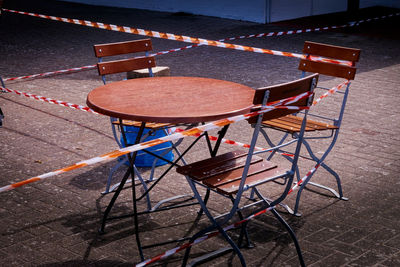 High angle view of empty chairs and tables in street