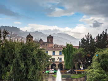 View of trees and buildings against sky