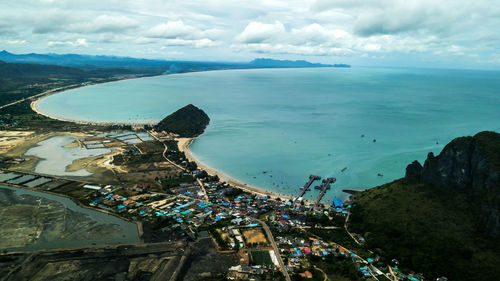 High angle view of sea and cityscape against sky