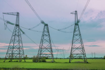 Low angle view of electricity pylon against sky