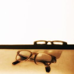 Close-up of sunglasses on table against white background
