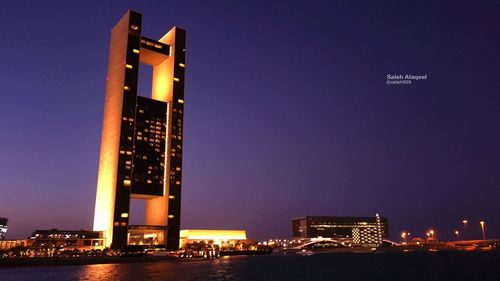 Low angle view of illuminated building against sky at night