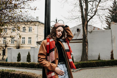 Full length of woman standing against building park 