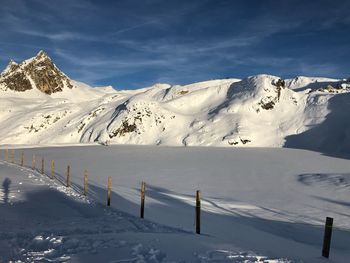 Scenic view of snow covered mountains against sky