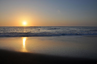 Scenic view of sea against clear sky during sunset