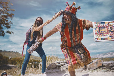 Representation of inca warrior dressed and with battle, prehispanic fighting with a tourist in peru