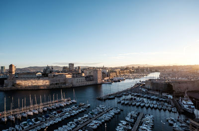 High angle view of river by city against clear sky