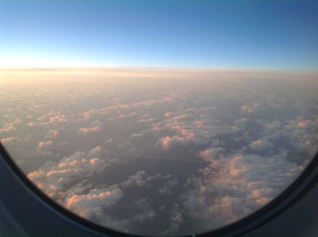 Cropped image of airplane wing over landscape