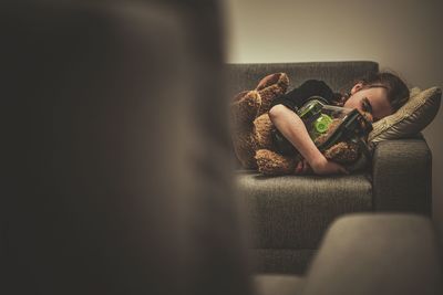 Girl lying on sofa at home