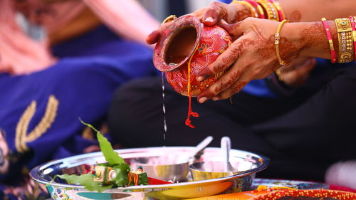 Midsection of man preparing food in bowl