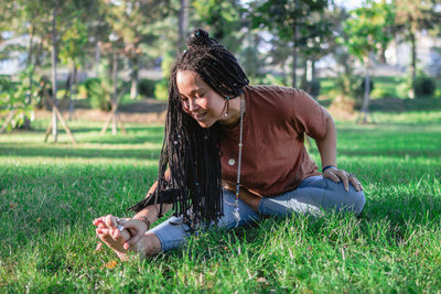 Beautiful young woman is doing yoga outside in a park. concept of healthy lifestyle.