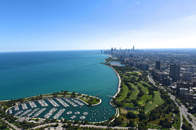 High angle view of buildings by sea against sky