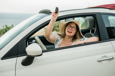 Portrait of smiling friends in car