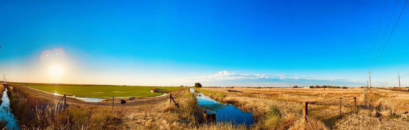 Panoramic view of landscape against blue sky