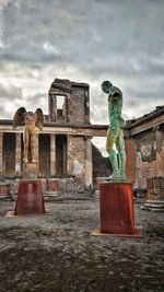 Statue of historical building against cloudy sky