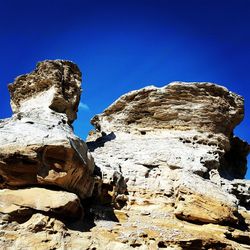 Close-up of stone wall against sky