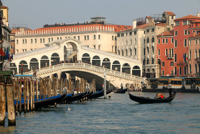 Gondolas, grand canal and rialto bridge in a romantic view of venice,