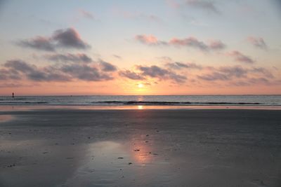 Scenic view of beach against sky during sunset