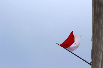 Low angle view of flag against clear sky