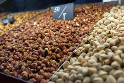 Lots of nuts on the counter at the fair, market, salted caramel almonds, fried pistachios. 