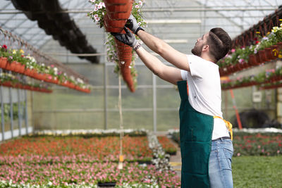 Midsection of woman holding flowering plants