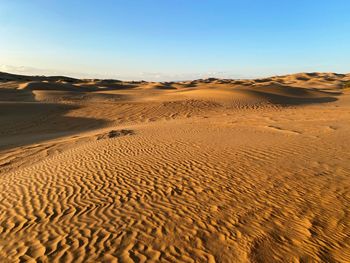 Scenic view of desert against clear sky